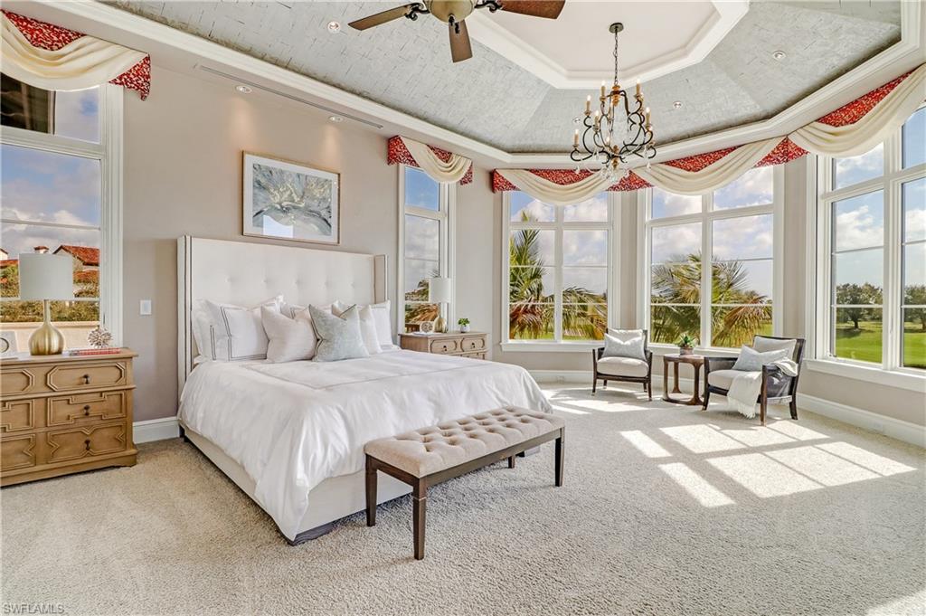 16622 Firenze Way Naples, FL 34110 - Photo 20 of 35 a spacious bedroom with a bed and a large window