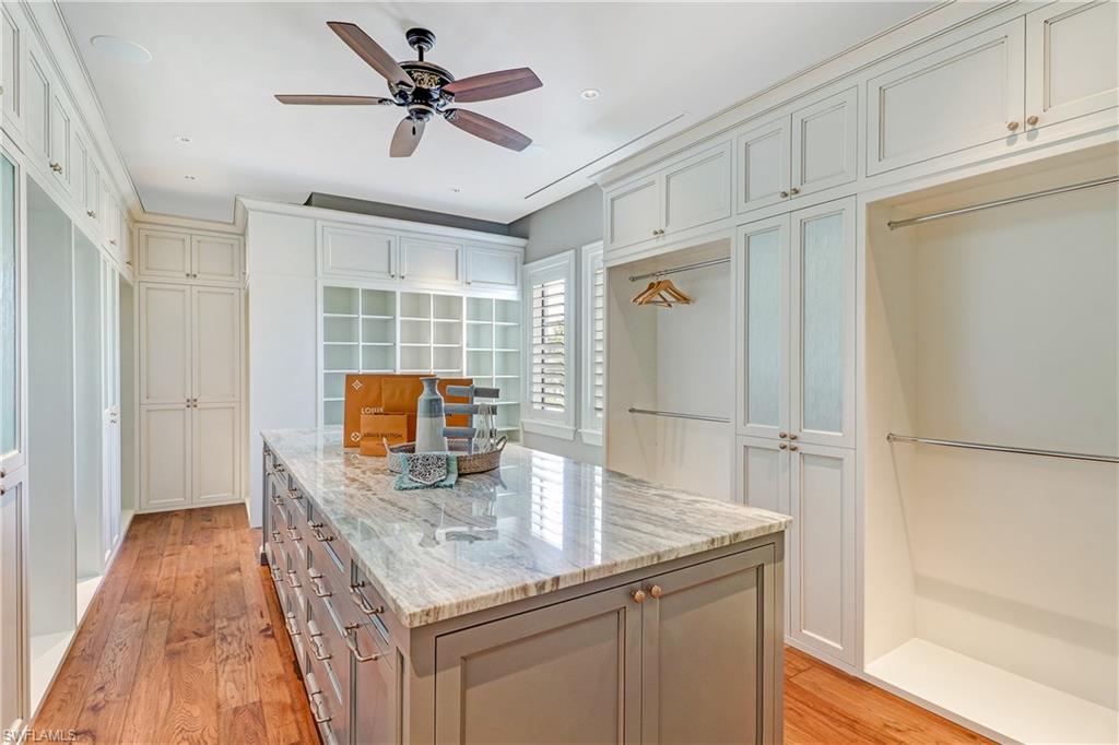 16622 Firenze Way Naples, FL 34110 - Photo 22 of 35 a kitchen with granite countertop a sink and cabinets