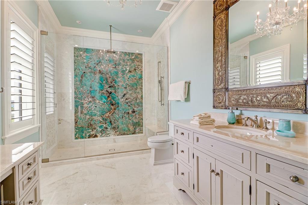 16622 Firenze Way Naples, FL 34110 - Photo 23 of 35 a bathroom with a granite countertop sink mirror vanity and next to a window