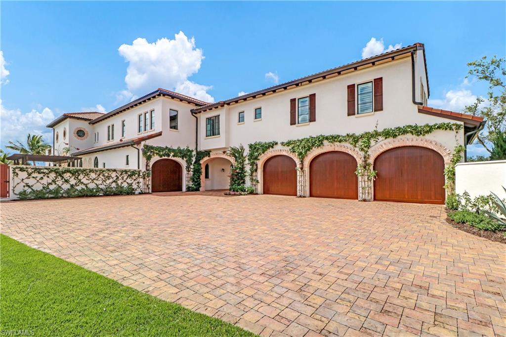 16622 Firenze Way Naples, FL 34110 - Photo 27 of 35 a front view of a house with a yard and garage
