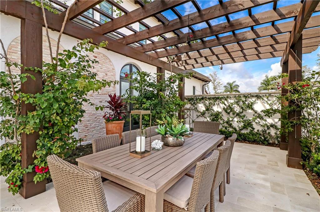 16622 Firenze Way Naples, FL 34110 - Photo 31 of 35 a outdoor dining space with furniture and potted plants