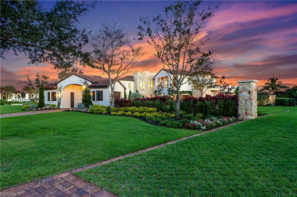 16622 Firenze Way Naples, FL 34110 - Photo 33 of 35 a front view of a house with garden