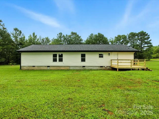 a front view of house with yard and trees