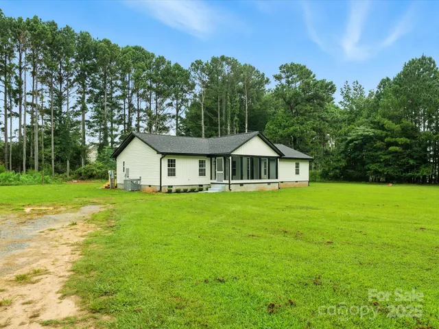 a front view of a house with yard and green space