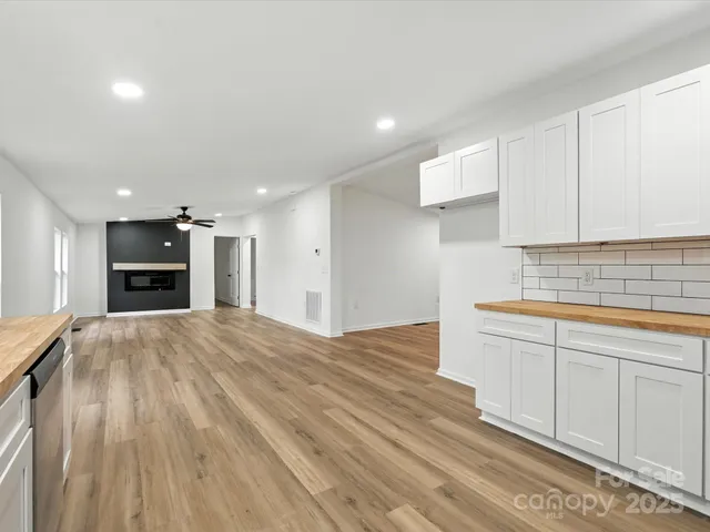 a open kitchen with kitchen island a sink stainless steel appliances and cabinets