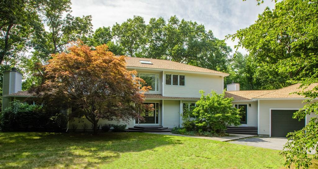 210 Elizabeth Ridge Road Carlisle, MA 01741 - Photo 1 of 25 a view of a house with a yard plants and large tree