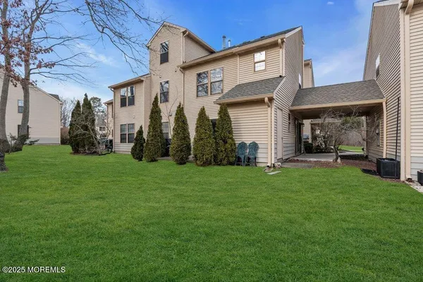 a front view of house with a garden