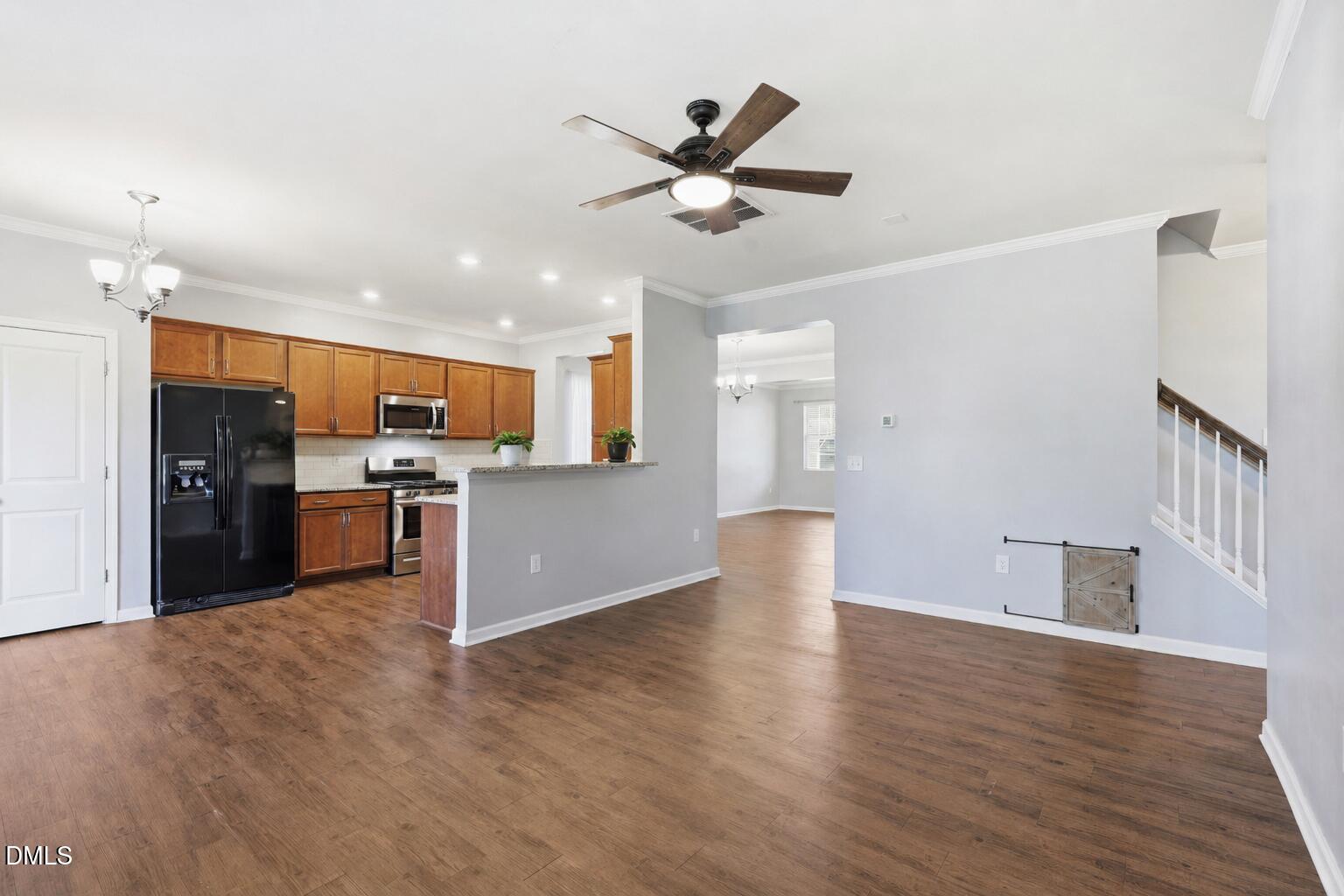 1808 Austin Rdg Parkway Wake Forest, NC 27587 - Photo 17 of 57 a view of an empty room with wooden floor and a kitchen