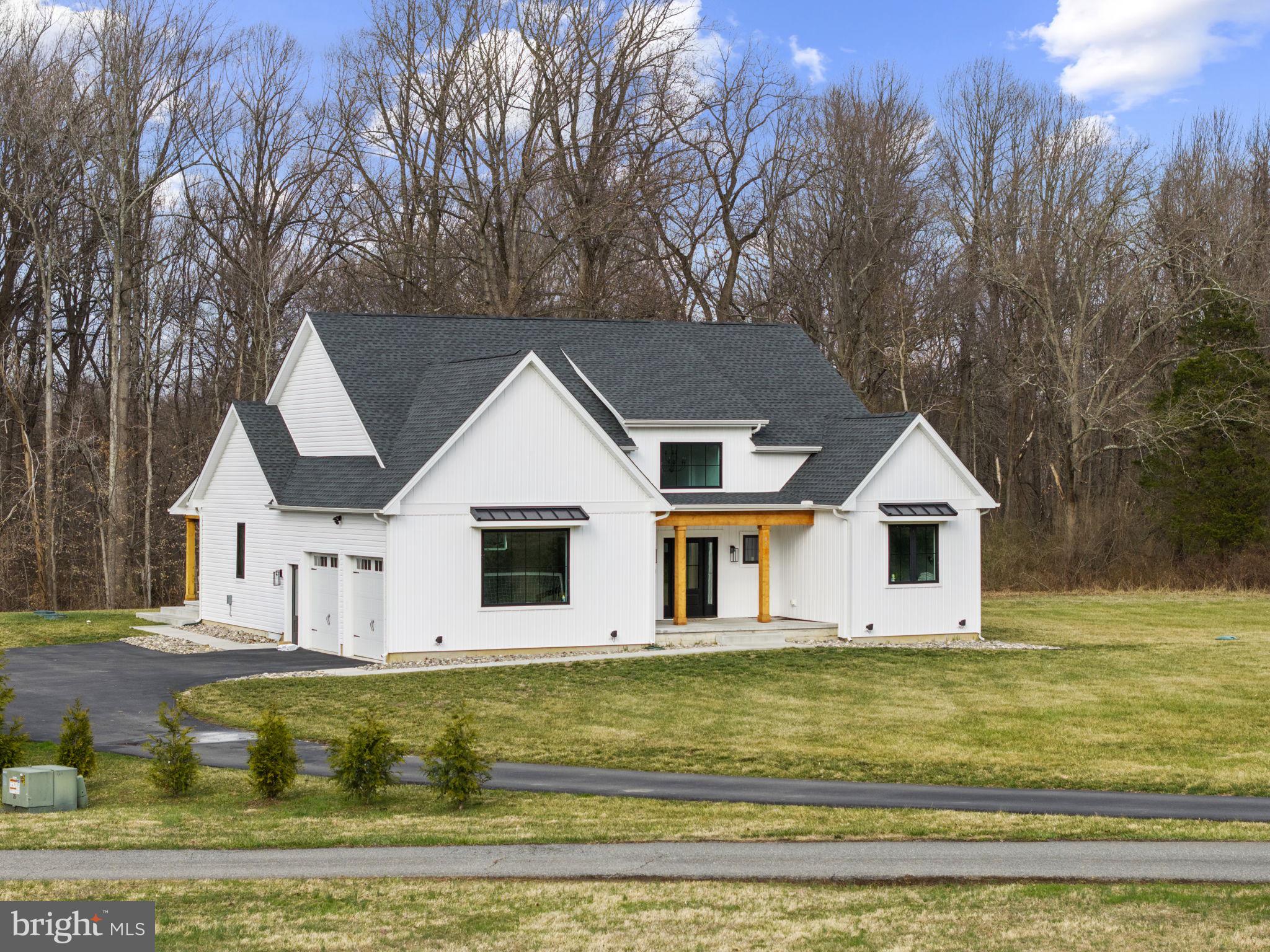 97 Otter Point Road Elkton, MD 21921 - Photo 2 of 64 a view of a white house with a large pool and large trees