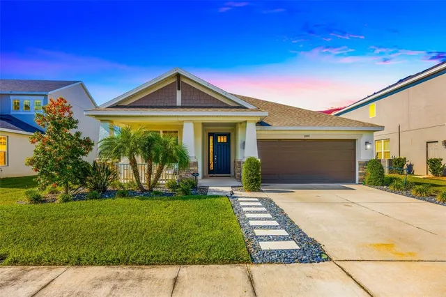 a front view of a house with a yard and garage