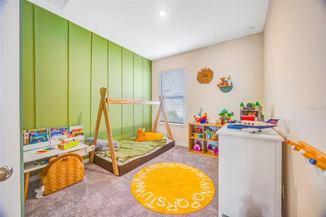 a bedroom with a bed and flat screen tv