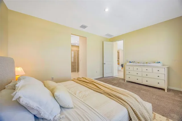 a white toilet sitting next to a white wall