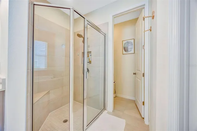 a dining room with furniture and a floor to ceiling window