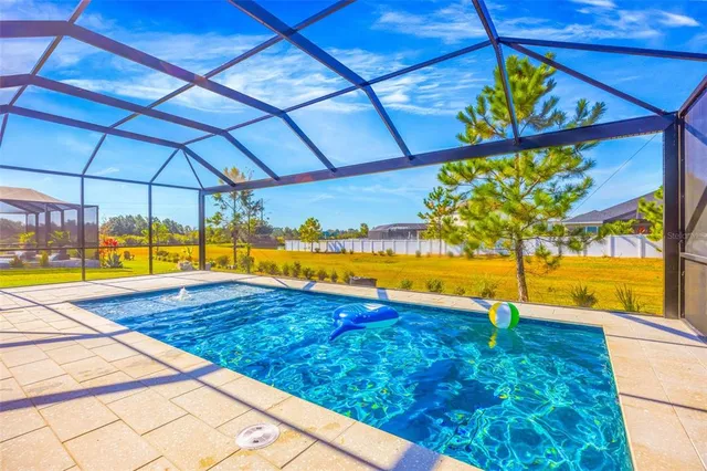 an aerial view of a house with a swimming pool