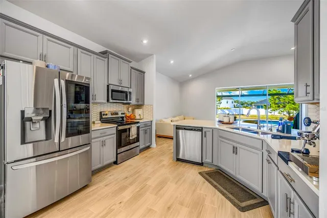 a kitchen with granite countertop white cabinets and sink