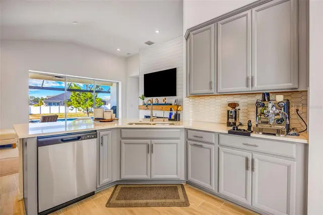 a living room with furniture a large window and wooden floor