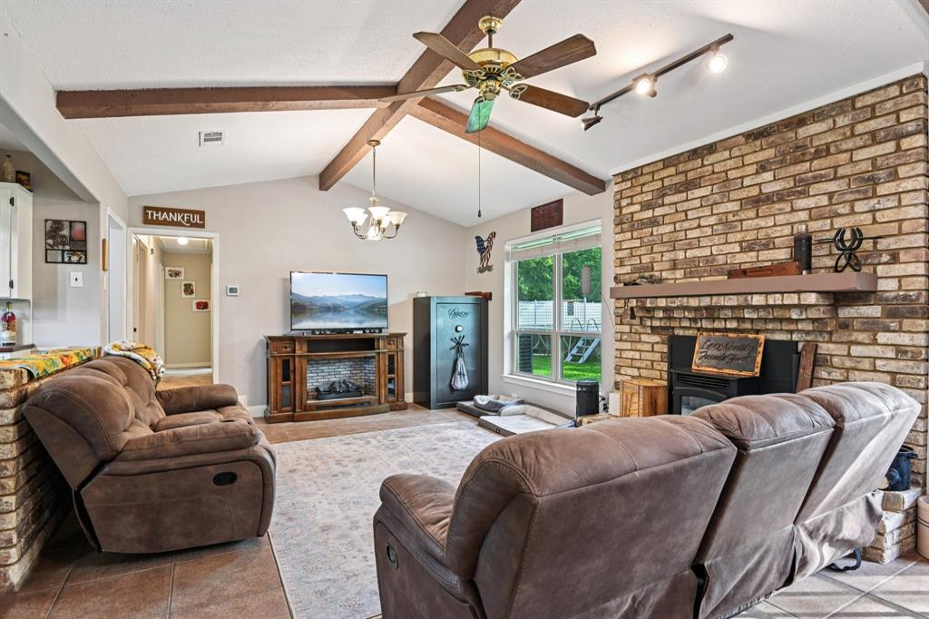 305 South Cockrell Hill Road Ovilla, TX 75154 - Photo 6 of 40 a living room with furniture a fireplace and a flat screen tv