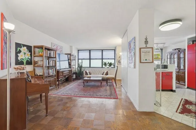 a living room with furniture and large window