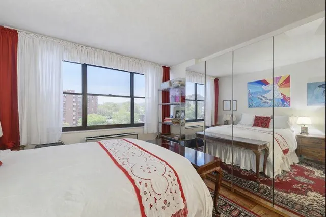 a bedroom with bed and window