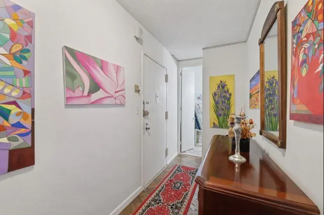 a room with painting on the wall and a window