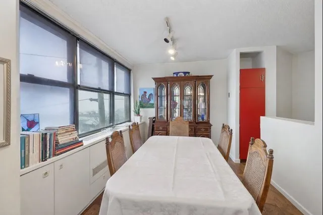 a large white kitchen with a large window