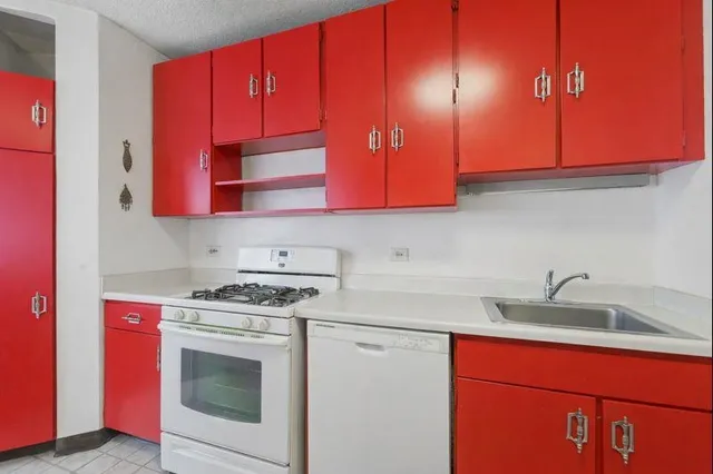 a kitchen with stainless steel appliances granite countertop a sink a stove and a microwave