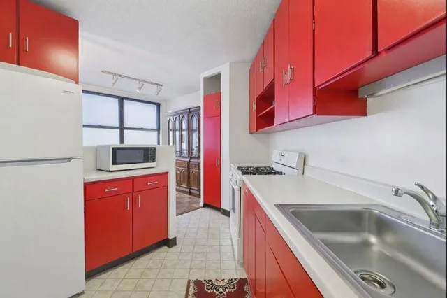 a kitchen with a sink stove and microwave