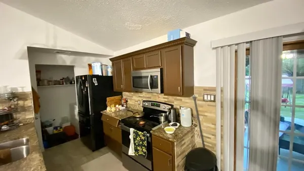 a kitchen with refrigerator and window