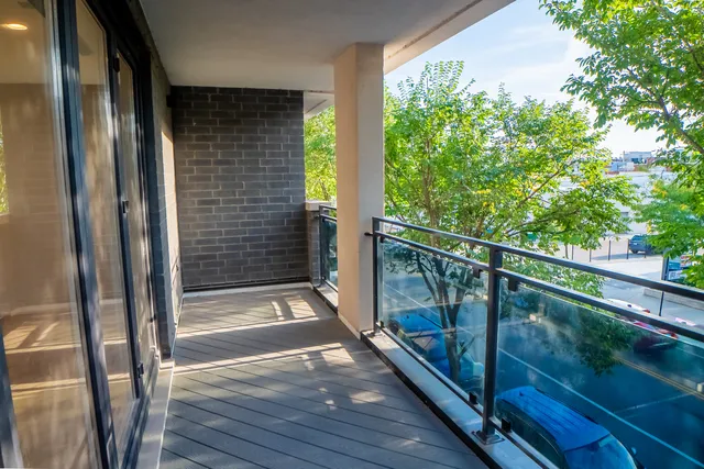 a view of balcony with floor to ceiling window and wooden floor