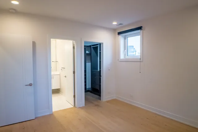 an empty room with windows and closet