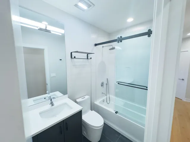 a bathroom with a sink toilet and shower