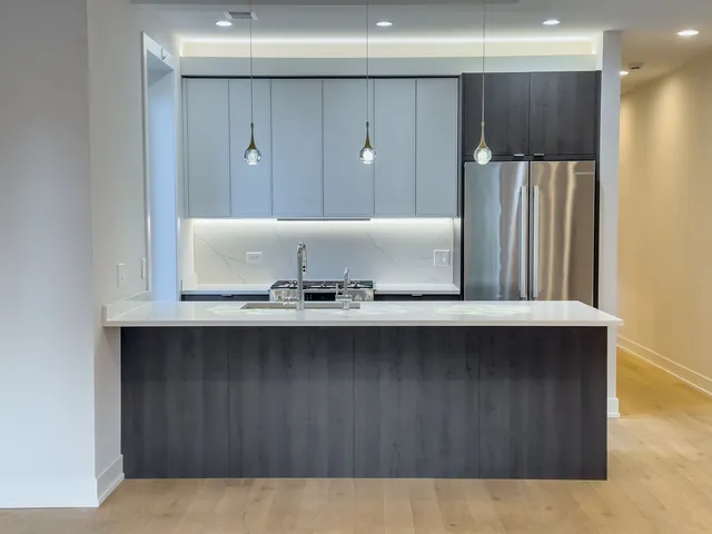 a kitchen with wooden cabinets and sink