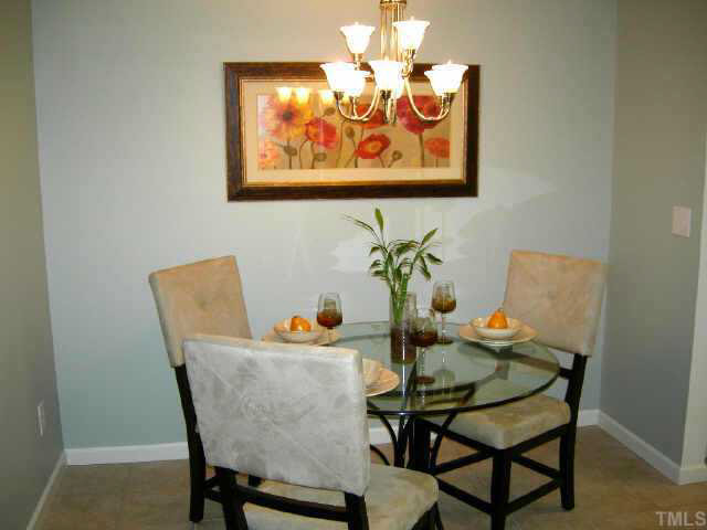 11321 Clubhaven Place Raleigh, NC 27617 - Photo 5 of 10 a dining room with furniture and wooden floor