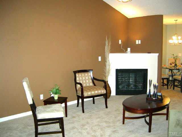 11321 Clubhaven Place Raleigh, NC 27617 - Photo 6 of 10 a living room with furniture and a fireplace