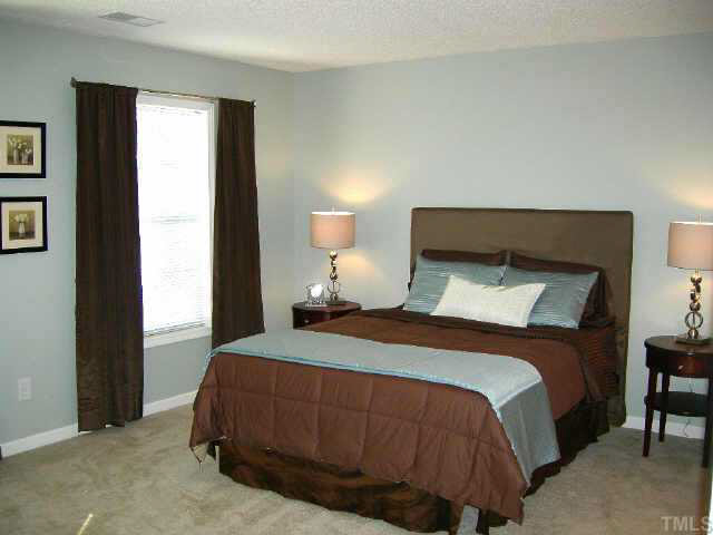 11321 Clubhaven Place Raleigh, NC 27617 - Photo 7 of 10 a bedroom with a bed and window
