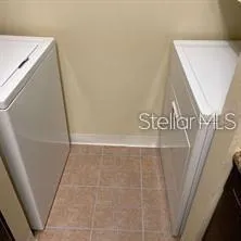 a view of walk in closet with clothes