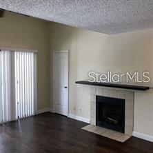 365 Forestway Circle, Unit 306 Altamonte Springs, FL 32701 - Photo 2 of 17 a hallway with wooden floor and a fireplace