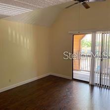 365 Forestway Circle, Unit 306 Altamonte Springs, FL 32701 - Photo 4 of 17 an empty room with wooden floor and windows