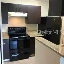 a stove top oven sitting inside of a kitchen