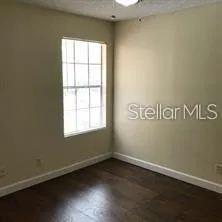 an empty room with wooden floor