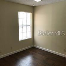 365 Forestway Circle, Unit 306 Altamonte Springs, FL 32701 - Photo 7 of 17 an empty room with wooden floor
