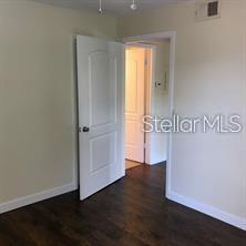 365 Forestway Circle, Unit 306 Altamonte Springs, FL 32701 - Photo 8 of 17 an empty room with wooden floor and window