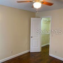 365 Forestway Circle, Unit 306 Altamonte Springs, FL 32701 - Photo 9 of 17 an empty room with wooden floor and mirror