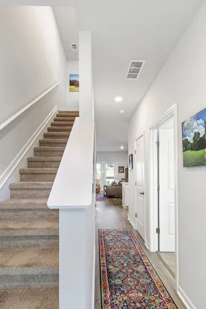 a view of a hallway with furniture and a rug