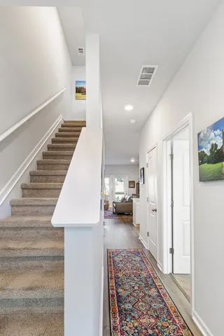 a view of a hallway with furniture and a rug