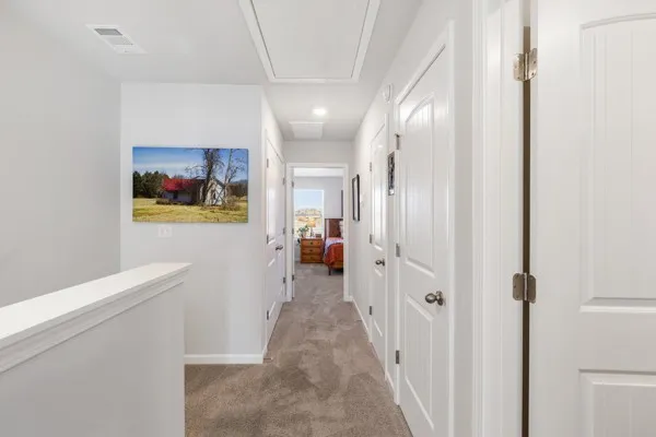 a view of a hallway view with wooden floor and staircase