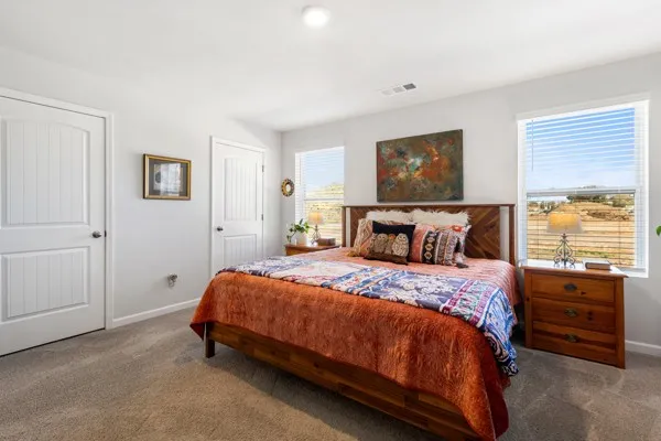 a bed sitting in a bedroom and dresser