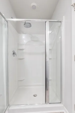 a bathroom with a glass shower door