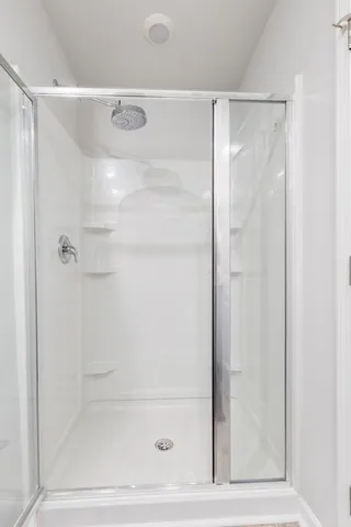 a bathroom with a glass shower door