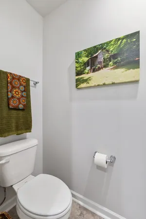 a white toilet sitting next to a shower curtain